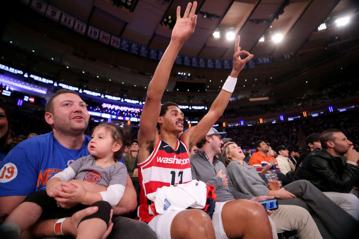 Washington Wizards guard Jordan Poole (13) reacts to a teammate's three point shot as he sits court side with fans during the third quarter against the New York Knicks at Madison Square Garden. Mandatory Credit: Brad Penner-USA TODAY Sports